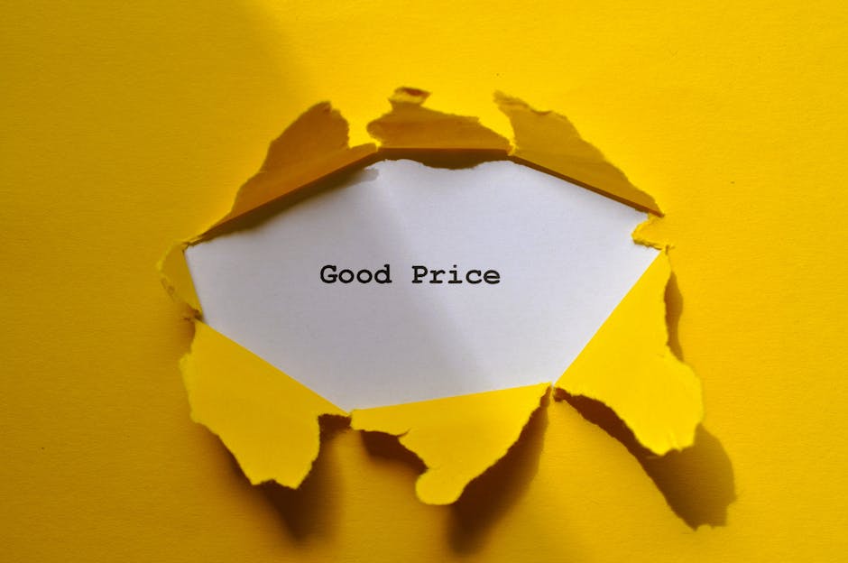 A yellow paper background with a hole torn in it, revealing a white inner surface that displays the message 'Good Price' typed in black text. The torn edges of the yellow paper are rough and jagged, c