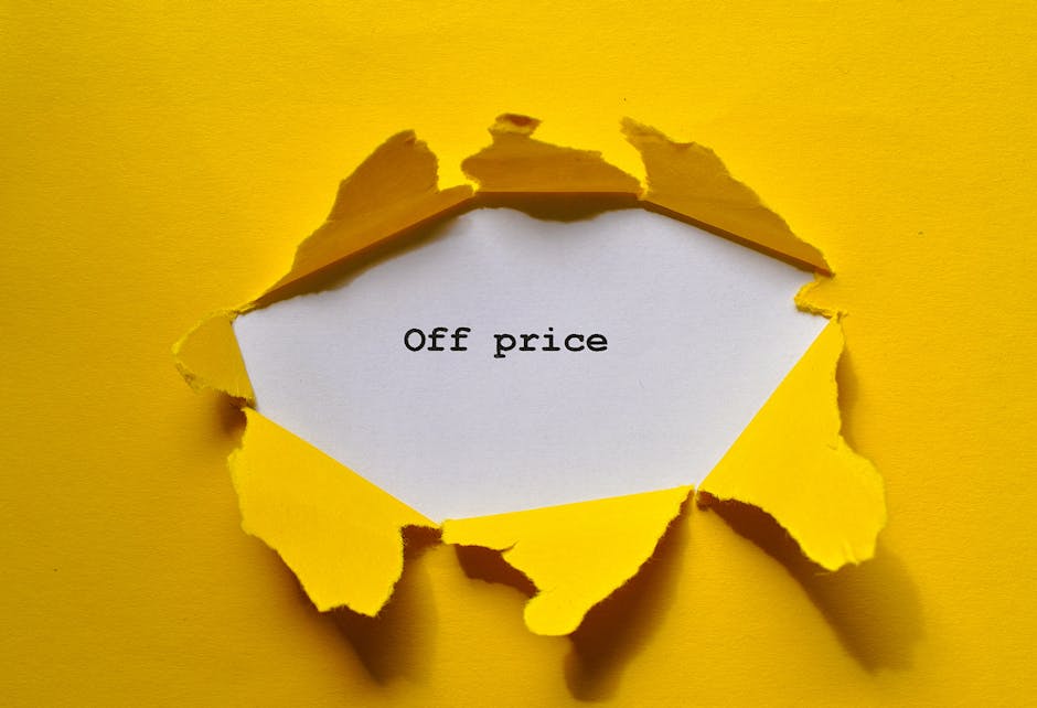 A yellow paper background with a hole torn in it, revealing a white inner surface that displays the message 'Good Price' typed in black text. The torn edges of the yellow paper are rough and jagged, c